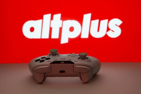 Dhaka, Bangladesh- 08 Apr 2025: A gaming controller in front of a AltPlus Inc screen