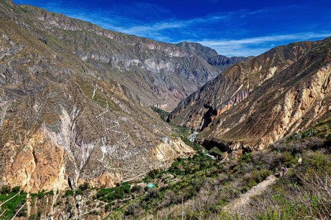 Extensive mountain landscape with a deep gorge under blue sky, The landscape of Colca Canyon in the
