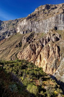 Large, steep rock walls with natural geological patterns, The landscape of the Colca Canyon in the