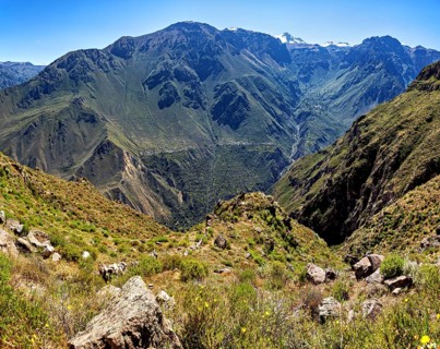 Dense vegetation in a wide valley between massive mountains and steep rock faces, The landscape of