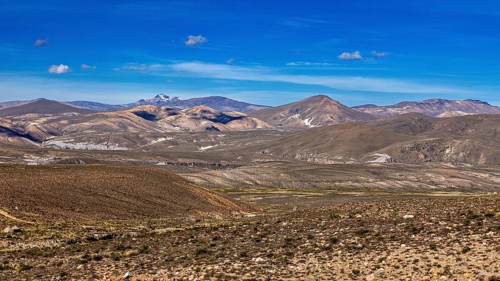 Hilly landscape with extensive desert and mountain range in the background, The Andean highlands of