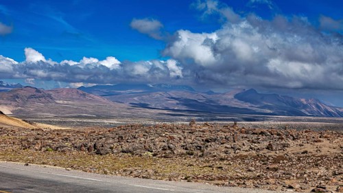 Rugged desert landscape with mountains and cloudy background in the distance, The highlands of the
