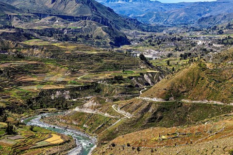 Wide views of terraced hills and flowing river, the landscape of Colca Canyon in the Aden of Peru