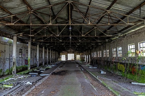 Abandoned hall with Grafity, dilapidated plant of a former agricultural production cooperative of