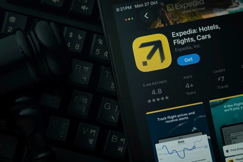 Dhaka, Bangladesh- 28 Oct 2025: An iPad displaying the Expedia app against a judge's gavel and dark