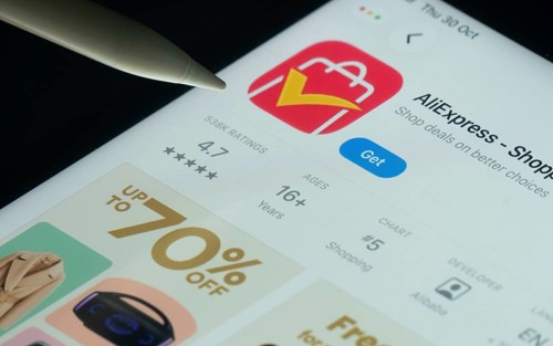 Dhaka, Bangladesh- 21 Nov 2025: AliExpress app on a iPad screen with a pen pointing at the install