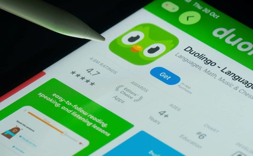 Dhaka, Bangladesh- 30 Oct 2025: Duolingo app on a iPad screen with a pen pointing at the install