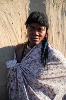 Portrait, brightly decorated woman of the Hakaona tribe, also Havakona or Hakawona, near Opuwo,
