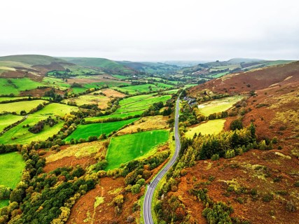 Autumn colours of Farms over River Wye and Road A470 from a drone, Llanidloes, Powys,