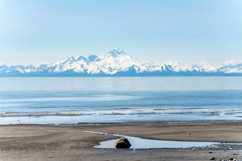 Beach at Anchor Point, Cook Inlet, glaciated mountain peaks of the Aleutian Range with Mount