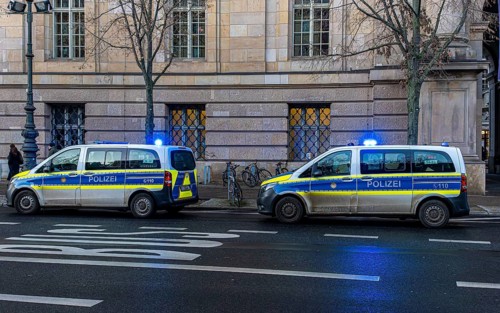 Police vehicles with flashing lights switched on, special operation at the Berlin State Library,