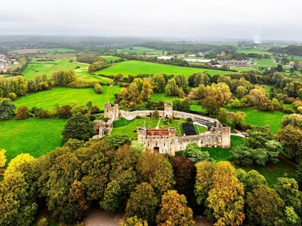 Autumn Colours over ruins of Caldicot Castle from a drone, Caldicot, Monmouthshire, Wales, UK