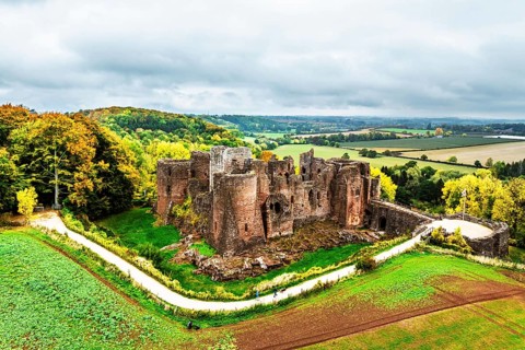 Autumn Colours over ruins of Goodrich Castle and River Wye from a drone, Goodrich, Herefordshire,