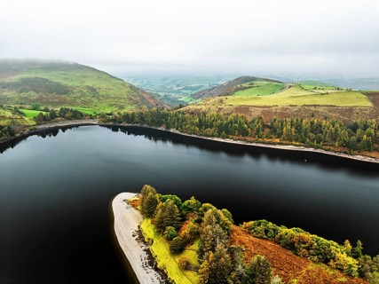 Autumn colours over Llyn Clywedog and Clywedog Reservoir from a drone, Llanidloes, Wales, UK