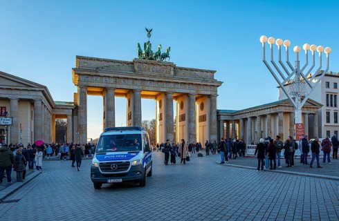Large Hanukkah chandelier at the Brandenburg Gate in daylight, sign of lively Jewish life, symbolic