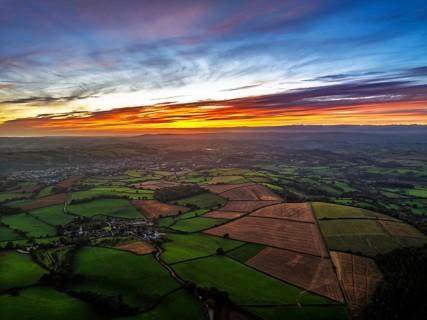 Sunset of Devon Farms and Fields over Berry Pomeroy from a drone, Totnes, England, United Kingdom