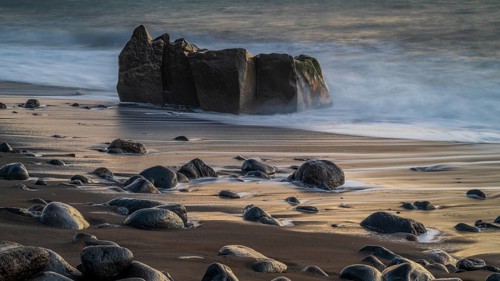 Sunset, waves and rocks in the sea, Praia Formosa, Madeira, Portugal