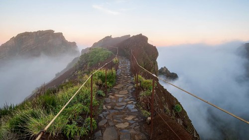 Sunrise at Pico do Arieiro, clouds of fog sweep over mountain peaks, sea of fog, hiking trail PR1,