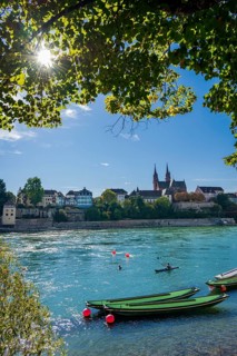 The Rhine with rowing boats in the sunshine in the late afternoon, Basel