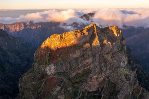 Aerial view, sunrise at Pico do Arieiro, clouds of fog sweeping over mountain peaks, Madeira,