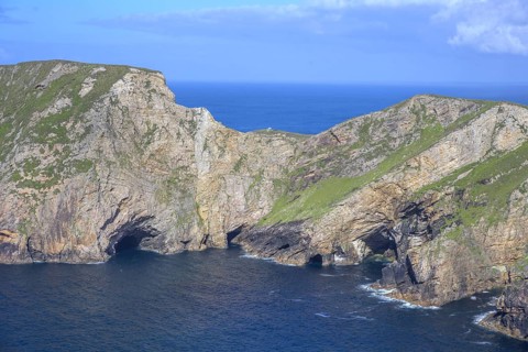 View of blue sea and cliffs with rock gate from Portacloy Loop Cliff Walk, Muingnabo, County Mayo,