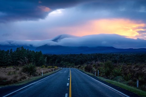 Mount Ngauruhoe in the morning at sunrise with glowing clouds, road SH 47. Tongariro National Park,