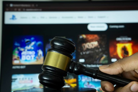 Dhaka, Bangladesh- 20 June 2025: A hand holds a gavel in front of a computer screen displaying