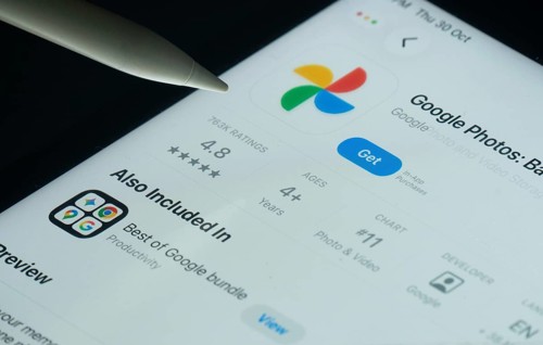 Dhaka, Bangladesh- 30 Oct 2025: Google Photos app on a iPad screen with a pen pointing at the
