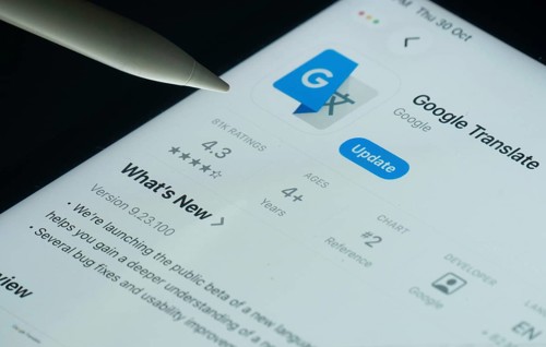 Dhaka, Bangladesh- 30 Oct 2025: Google Translate app on a iPad screen with a pen pointing at the