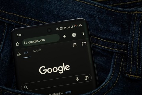 Dhaka, Bangladesh- 15 June 2025: A smartphone displaying the Google web interface peeks out of a