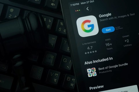 Dhaka, Bangladesh- 28 Oct 2025: An iPad displaying the Google app against a judge's gavel and dark
