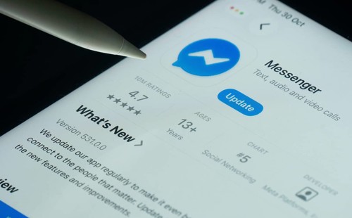Dhaka, Bangladesh- 30 Oct 2025: Facebook Messenger app on a iPad screen with a pen pointing at the