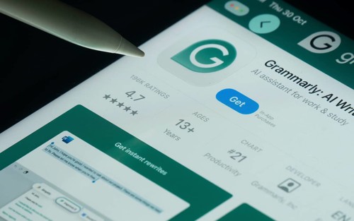 Dhaka, Bangladesh- 30 Oct 2025: Grammarly app on a iPad screen with a pen pointing at the install