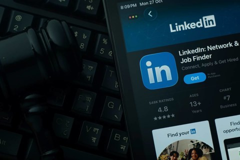 Dhaka, Bangladesh- 28 Oct 2025: An iPad displaying the LinkedIn app against a judge's gavel and