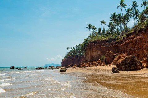 Lonely beach with red rocks and coconut trees, Red Cliffs, Bang Saphan Noi, Prachuap Khiri Khan