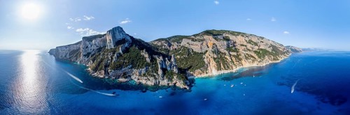 Panorama, picturesque rocky coast, cliffs with L'Aguglia pinnacle, blue sea and Cala Goloritzé