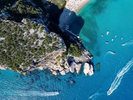 Picturesque rocky coast, cliffs and Cala Luna beach, aerial view, top-down, Golfo di Orosei,
