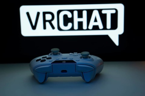 Dhaka, Bangladesh- 14 Nov 2025: A close-up of a white gamepad with the VRChat seen on screen in the