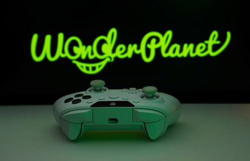 Dhaka, Bangladesh- 14 Nov 2025: A close-up of a white gamepad with the WonderPlanet Inc seen on
