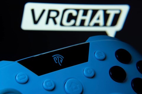 Dhaka, Bangladesh- 14 Nov 2025: A close-up of a gamepad with the VRChat seen on screen in the