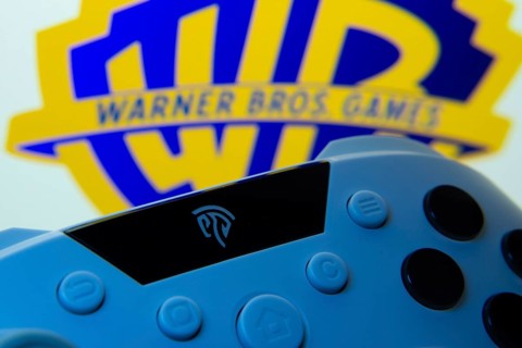 Dhaka, Bangladesh- 14 Nov 2025: A close-up of a gamepad with the Warner Bros. Games seen on screen
