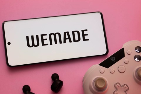 Dhaka, Bangladesh- 22 Mar 2025: Smartphone with WeMade Entertainment logo, game controller, and
