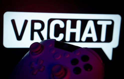 Dhaka, Bangladesh- 14 Nov 2025: A close-up of a gamepad with the VRChat seen on screen in the