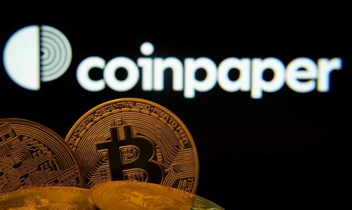 Dhaka, Bangladesh- 19 Sep 2025: Close-up of Bitcoin coins with the Coinpaper logo visible on a