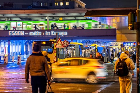The main train station in Essen, blue illuminated underpass, bus station, am Europaplatz, train on