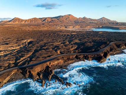 Coast with lava fields, volcanic landscape near Los Hervideros, in the evening light, aerial view,