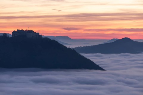 Sunset over the sea of fog from Beurener Fels to Hohenneuffen Castle, Swabian Alb,