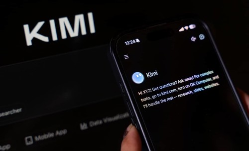 In this photo illustration, a person uses the Kimi AI chatbot on a smartphone while the KIMI logo