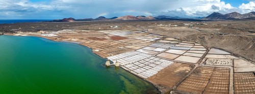 Salt mining plant, Salinas de Janubio with green Laguna de Janubio, near Yaiza, aerial view,