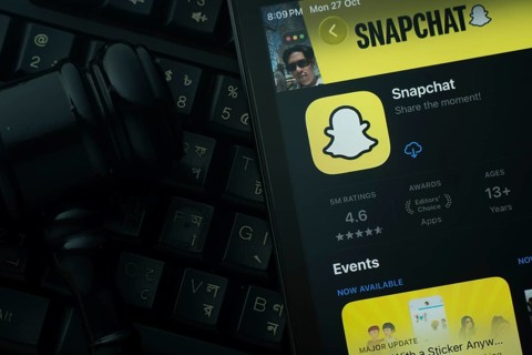 Dhaka, Bangladesh- 28 Oct 2025: An iPad displaying the Snapchat app against a judge's gavel and